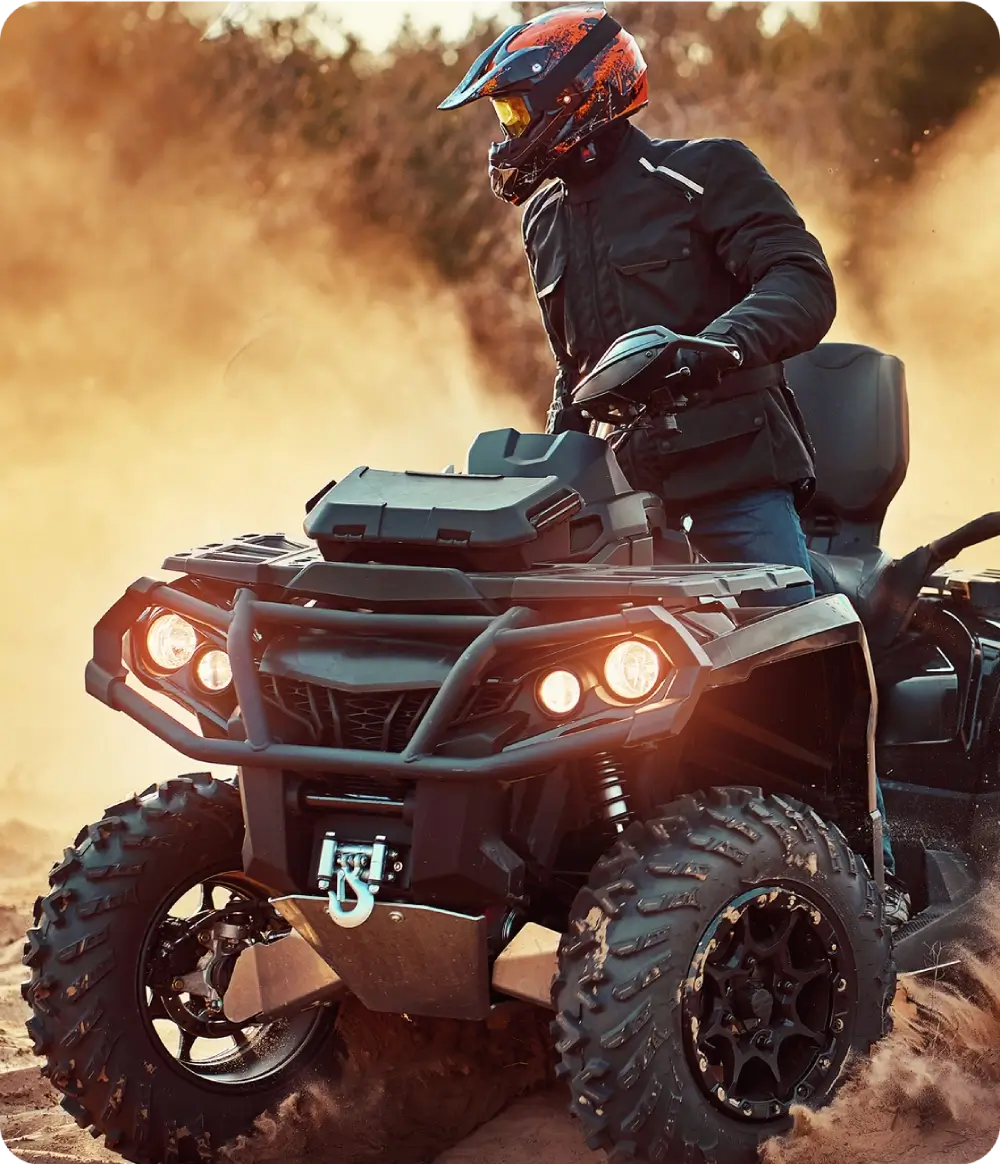 Close up of ATV front with helmeted rider