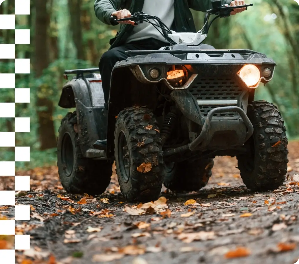 ATV on a leaf-covered forest trail.