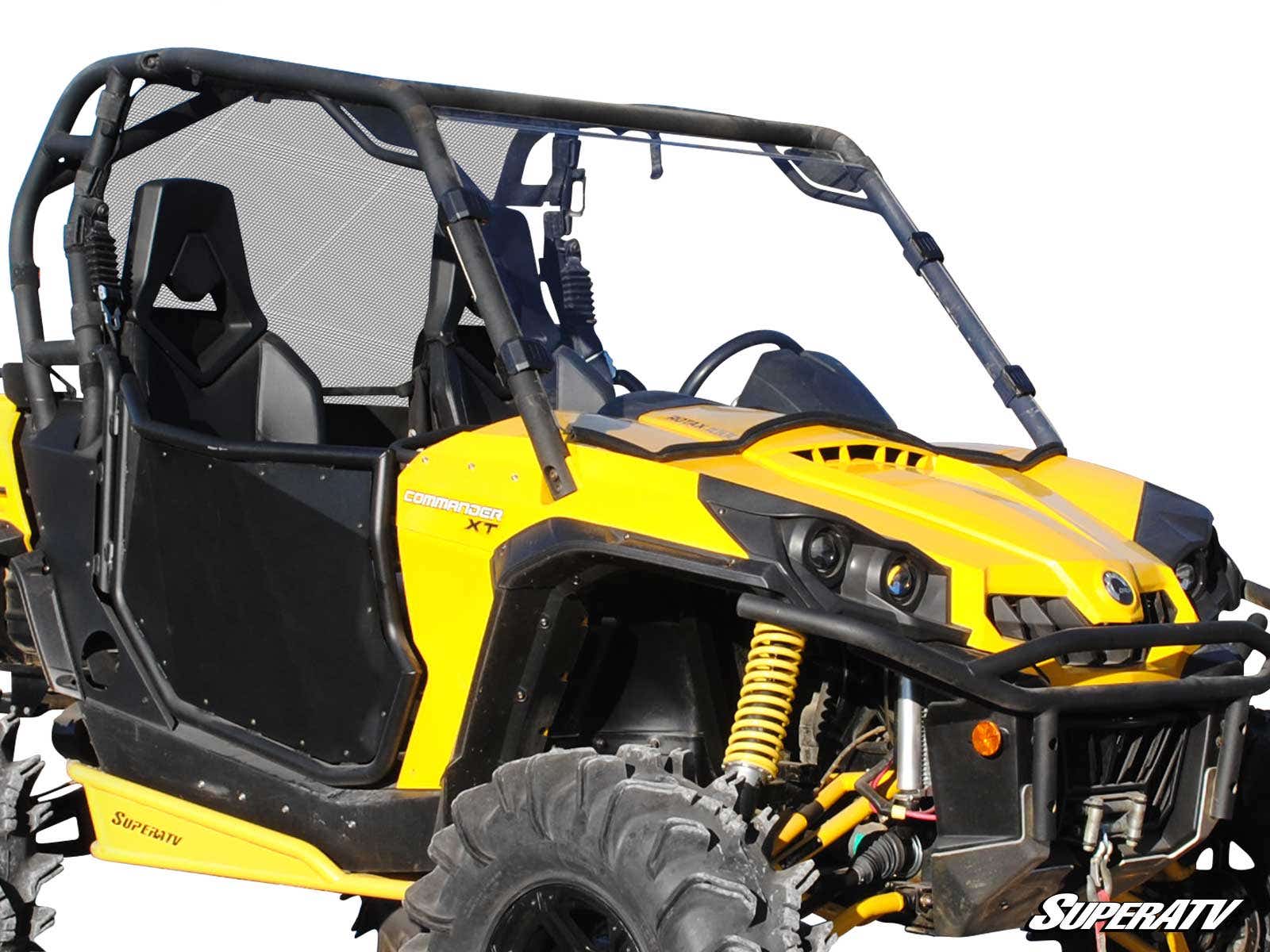 Yellow off-road side-by-side vehicle with large tires and roll cage.