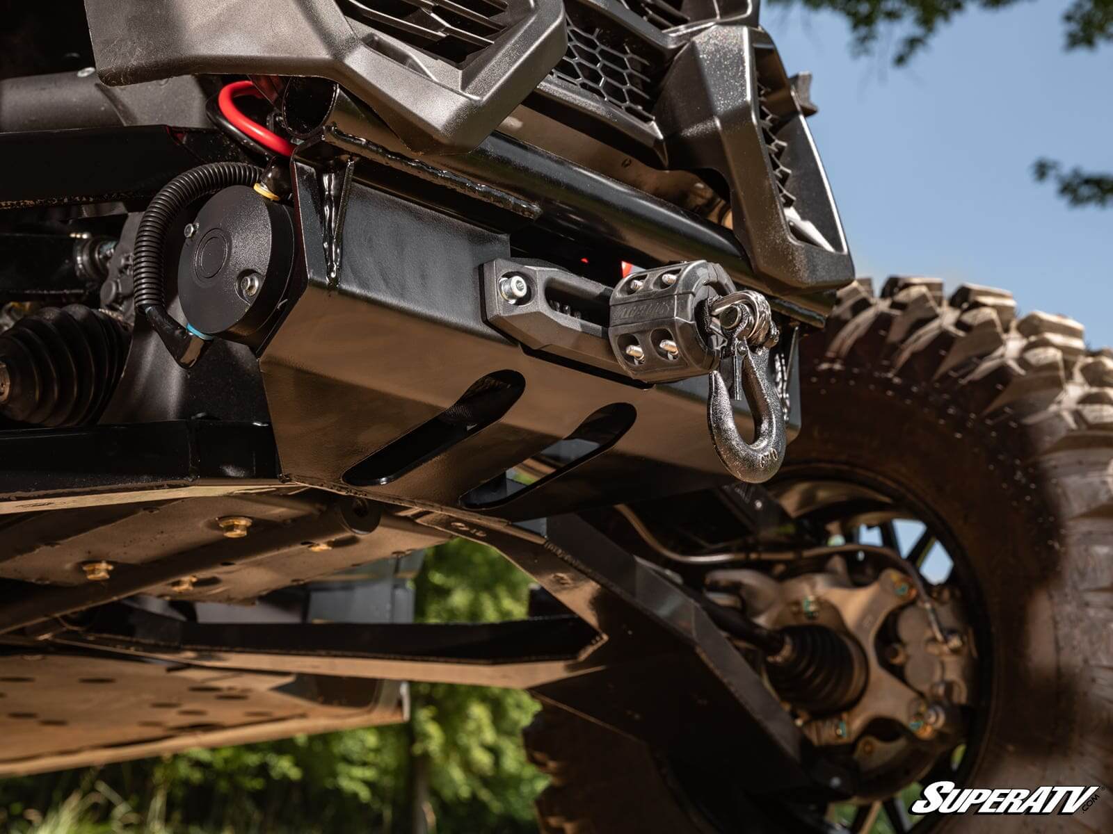 Close-up of a rugged off-road vehicle bumper with a winch and tow hooks.