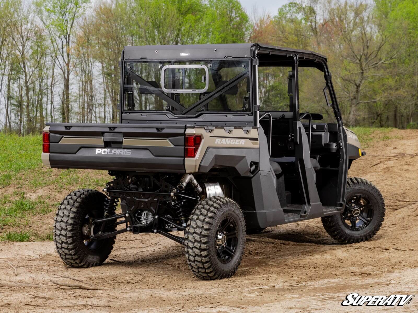 Black utility off-road vehicle parked outdoors on grass.