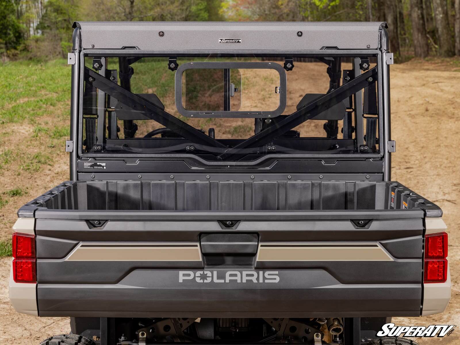 Rear view of a Polaris off-road vehicle with an open cargo bed.