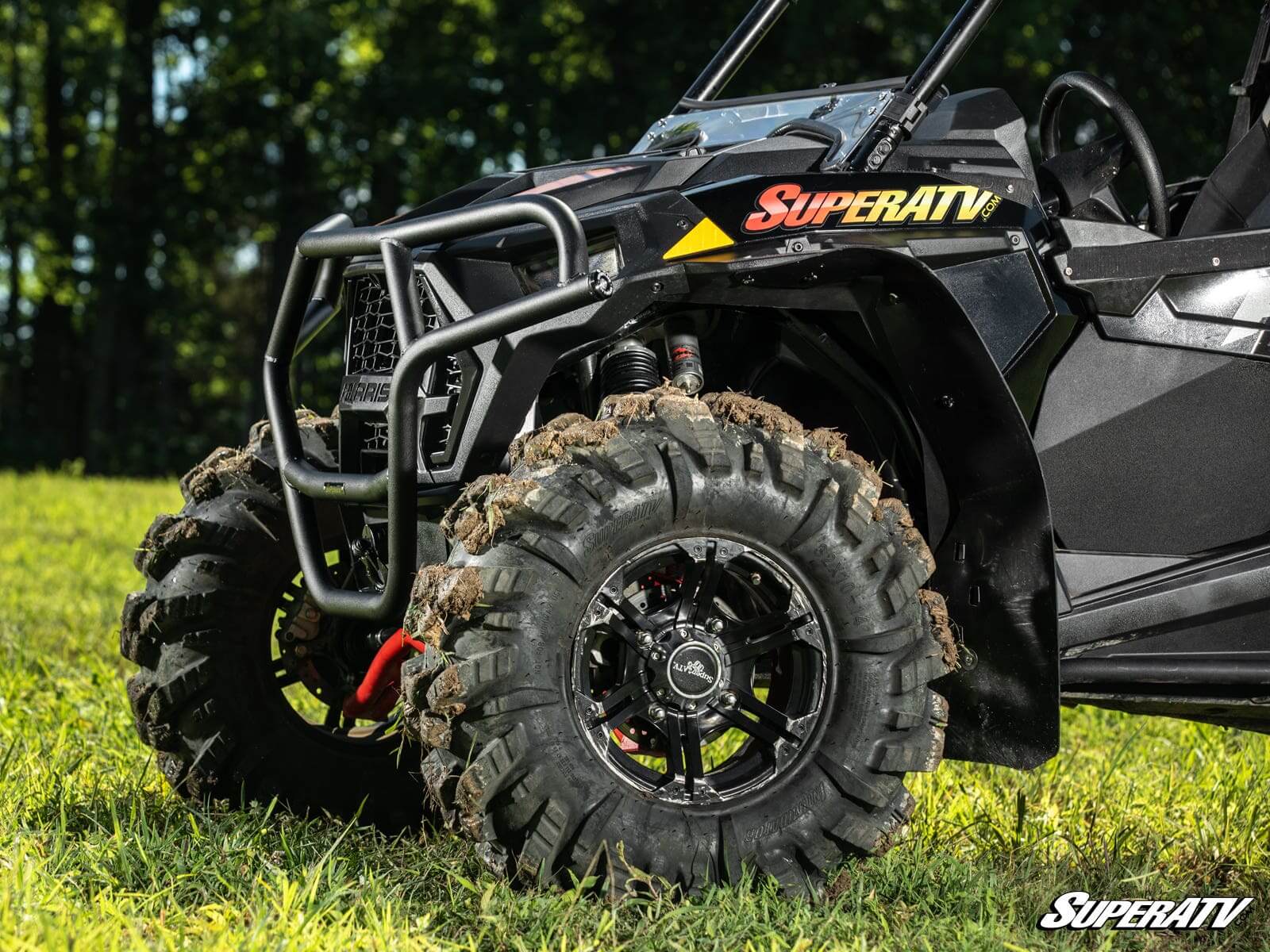 Off-road vehicle with rugged tires on grass.