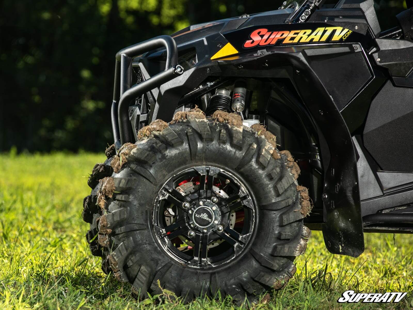 Close-up of a rugged off-road ATV tire with deep treads.