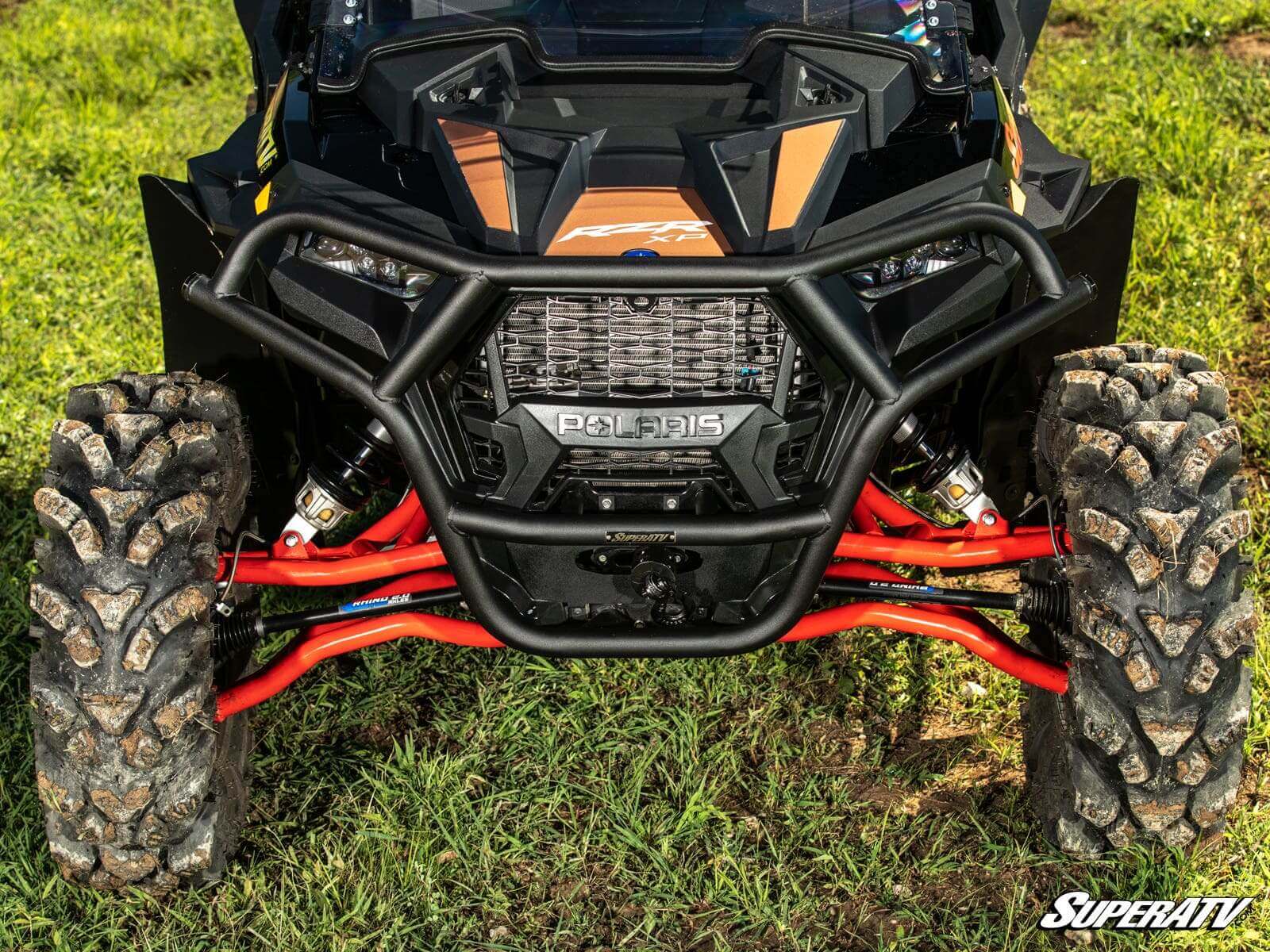 Close-up of an off-road vehicle's front suspension and LED light bar.