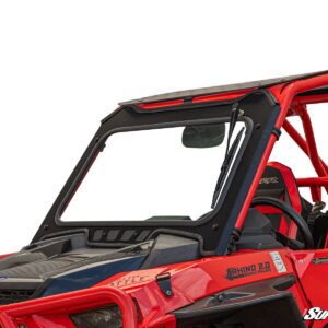 Red off-road vehicle with roll cage and windshield.