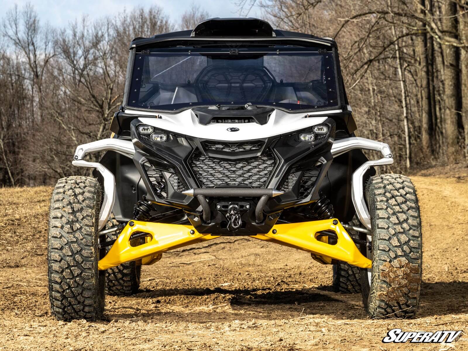 Front view of a rugged off-road vehicle with large tires and yellow suspension arms.