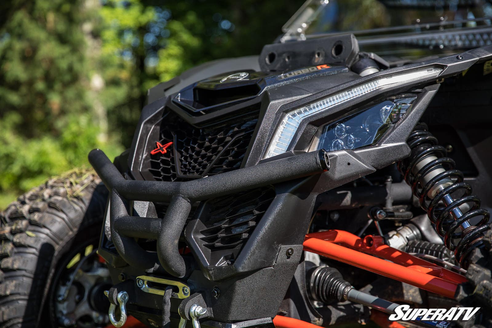 Close-up of a rugged off-road vehicle front with a winch and protective bumper.