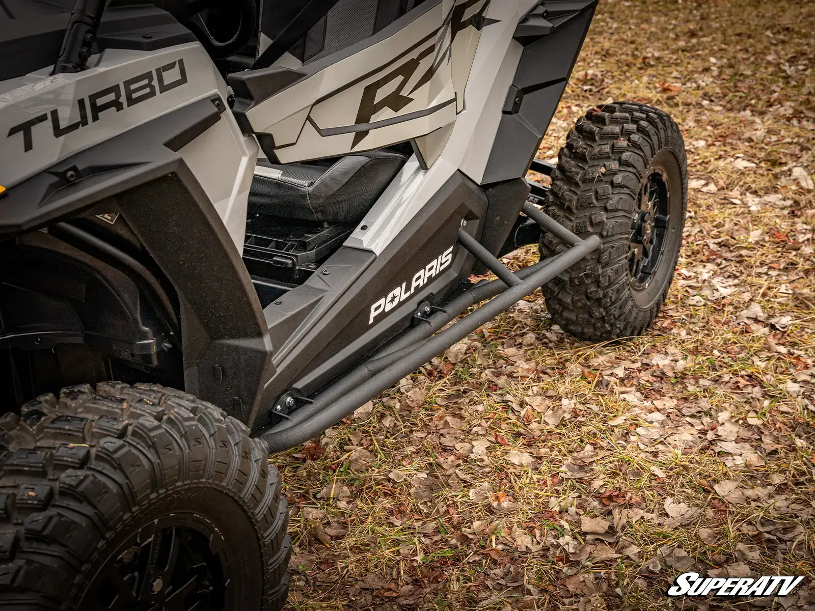 Off-road vehicle with rugged tires, side view.