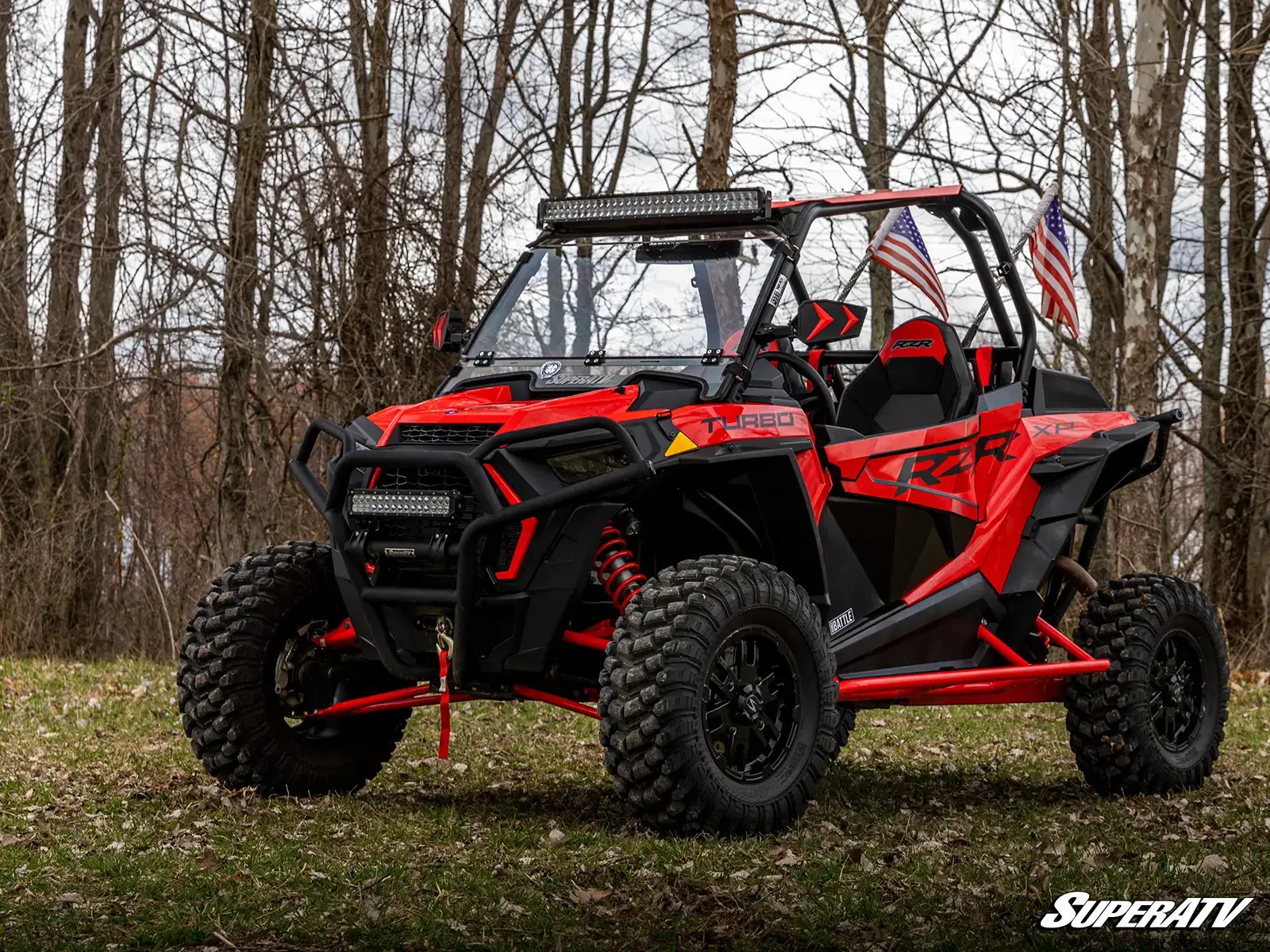 Red off-road vehicle with American flags.