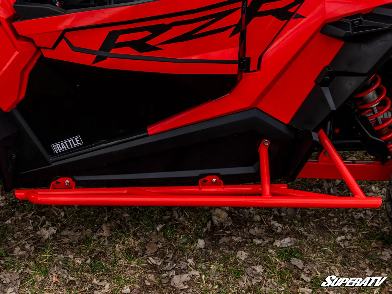 Red off-road vehicle with protective side panel.